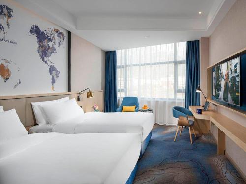 Giường trong phòng chung tại Kyriad Marvelous Hotel Tai'an City Hall Plaza