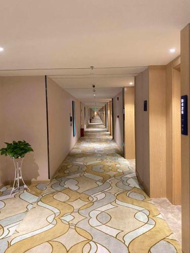 a hallway with a carpeted floor in a building at Kyriad Marvelous Hotel Zhongshan West District in Changzhou