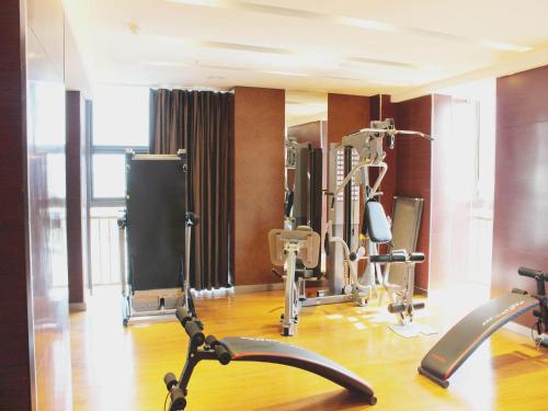 a gym with cardio equipment in a room at JinJiang Inn Fashion Zhenjiang Dagang Pingchang Road in Zhenjiang