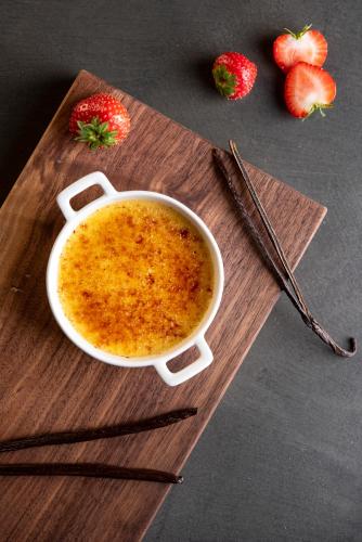 a cup of soup on a cutting board with strawberries at Romantik Hotel Oberwirt in Marlengo