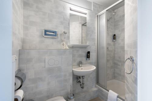 a bathroom with a toilet and a sink and a shower at a&o Berlin Friedrichshain in Berlin