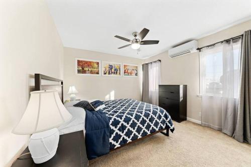 a bedroom with a bed and a ceiling fan at Cozy and Bright Centrally Located NEW 2BR Property! in Inglewood