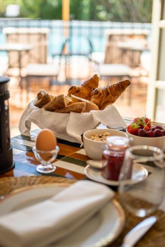 a table with a tray of bread and eggs and food at Château les Crostes in Lorgues