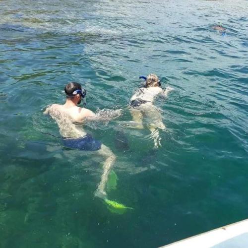 two people in the water with a fish in the water at Maha Nusa Menjangan in Banyuwedang