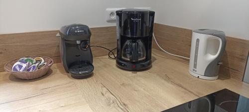 two black blenders are sitting on a counter next to a waffle at Le Repos du Randonneur in Audinghen