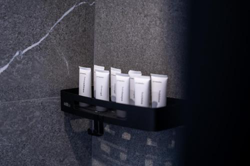 a shelf with a row of white candles on a wall at Island Sea Side Hotel - Adults Only in Rhodes Town
