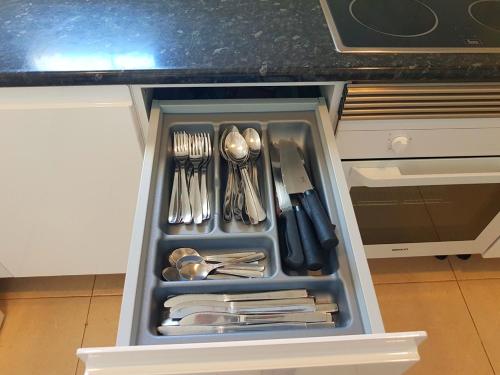 a drawer filled with silver utensils in a kitchen at Ferienhaus in Can Picafort, nahe Playa de Muro, 4 x Schlafzimmer mit Bad in Can Picafort