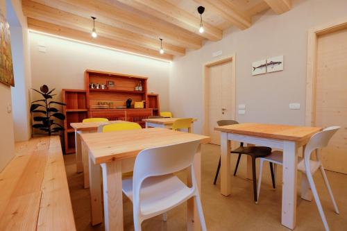 a dining room with wooden tables and chairs at Casa Carolina in Levico Terme