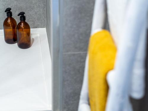 a close up of two bottles of soap in a bathroom at Apartment Abora with Pool, Gym and Free Parking in Las Palmas de Gran Canaria