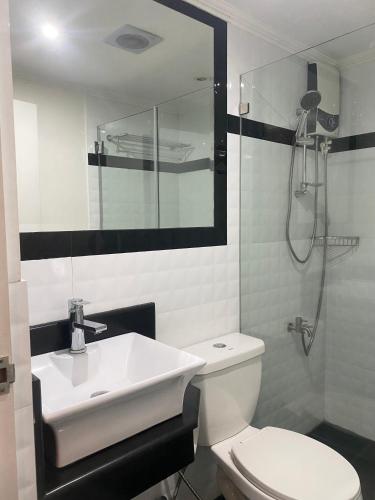 a bathroom with a sink and a toilet and a shower at MAKATI Isabela Luxury in Manila