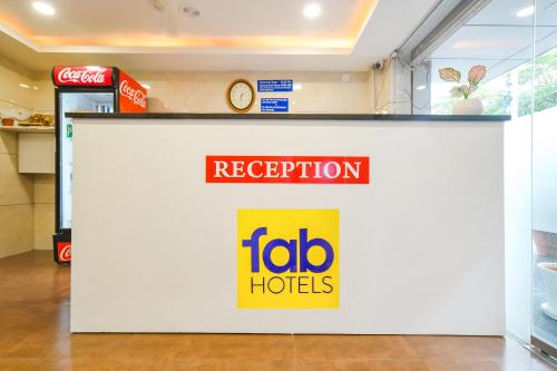 a sign for a lobo hotel on a wall at FabHotel Ten Eleven in Indore