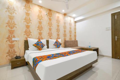 a bedroom with a large bed in a room at FabHotel Ten Eleven in Indore