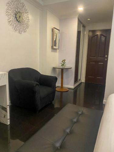 a living room with a couch and a table at MAKATI Isabela Luxury in Manila