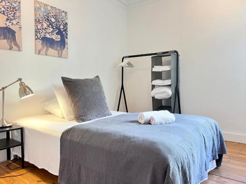a bedroom with a bed with a blue blanket at Two Bedroom Apartment In Copenhagen, Brohusgade 16, in Copenhagen