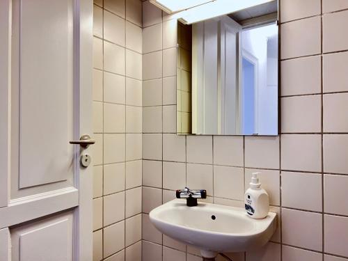 a bathroom with a sink and a mirror at Two Bedroom Apartment In Copenhagen, Brohusgade 16, in Copenhagen