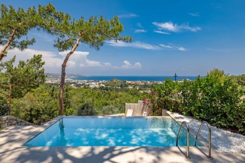 a swimming pool with a view of the ocean at Aegean View Estate - Villa in Faliraki