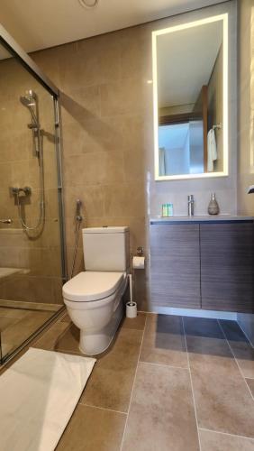 a bathroom with a toilet and a shower and a sink at STAY BY LATINEM Luxury 2BR Holiday Home CV B601 near Burj Khalifa in Dubai