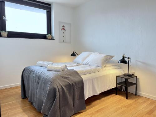 a bedroom with a large bed and a window at Two Bedroom Apartment In Glostrup, Hovedvejen 182, in Glostrup