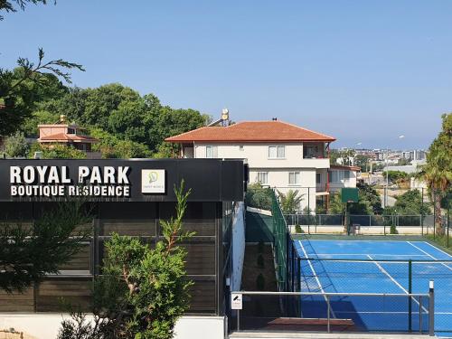 a tennis court with a sign for a royal park boutique residence at A dream house with a dream view in ROYAL PARK in Alanya