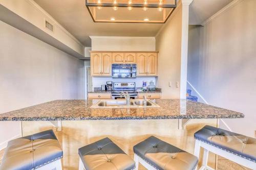 a kitchen with a large counter with stools at Sandy Fox- Walk to Beach, Private pool, Sleeps 26 in Gulf Shores