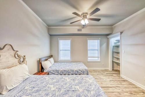 a bedroom with two beds and a ceiling fan at Sandy Fox- Walk to Beach, Private pool, Sleeps 26 in Gulf Shores