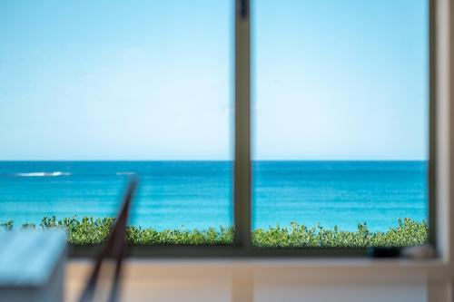 a desk with a laptop and a view of the ocean at Silver Moon at Half Moon in Bicheno