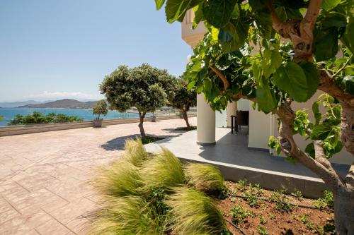 a patio with trees and the ocean in the background at Balos Beach in Kissamos
