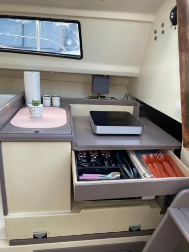 a kitchen inside of a rv with a desk at Logement atypique in Cap d'Agde