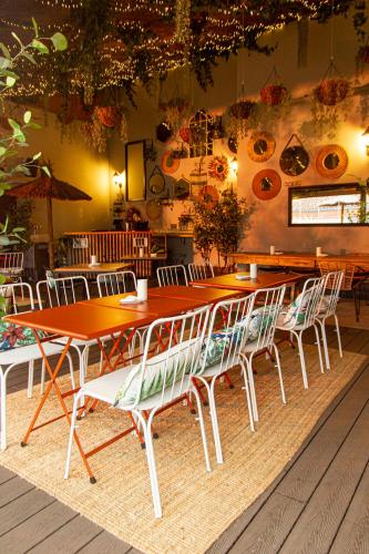 a long table and chairs in a restaurant at The Central House Madrid Lavapiés in Madrid