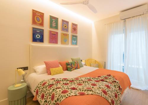 a bedroom with a bed with colorful pillows at Iturriza AC by Staynnapartments in Bilbao