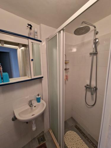 a bathroom with a shower and a sink at Shabby chic beach cottage Hvar in Hvar
