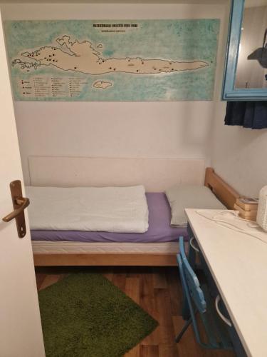 a small room with a bed and a desk at Shabby chic beach cottage Hvar in Hvar