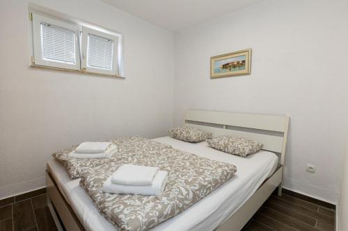 a bedroom with a bed with two pillows on it at Andrea&Goran in Selce