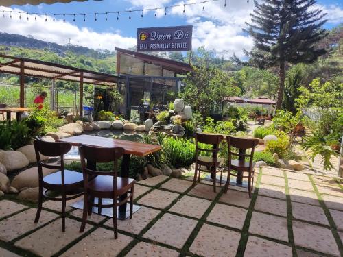 a table and chairs in front of a restaurant at GREENECO DA LAT HOTEL - Khách sạn Green Eco Đà Lạt in Da Lat