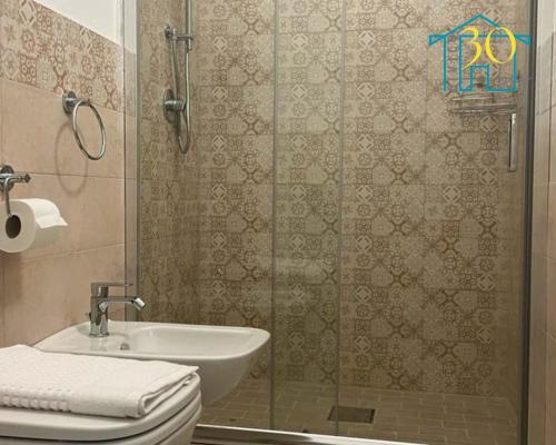 a bathroom with a shower and a toilet and a sink at CIVICO 30 bis in Santa Domenica
