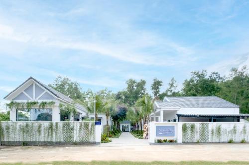 a house with a fence in front of it at NatalieLe's Homestay in Phu Quoc