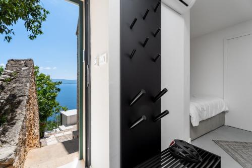 a door to a bedroom with a view of the ocean at Murvica resport in Murvica