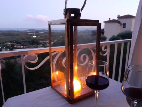 a lantern and a glass of wine on a table at Ginestre38 in Pula