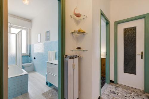 a bathroom with a tub and a sink and a toilet at Riva Mare 1 in Vado Ligure