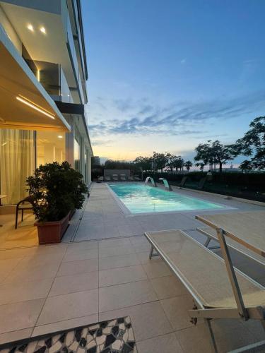 a house with a swimming pool and a house at Hotel Ascot Riccione in Riccione