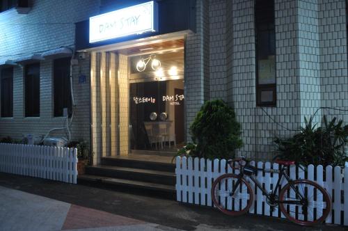 a bike parked in front of a store at Dam Stay Jeju in Jeju