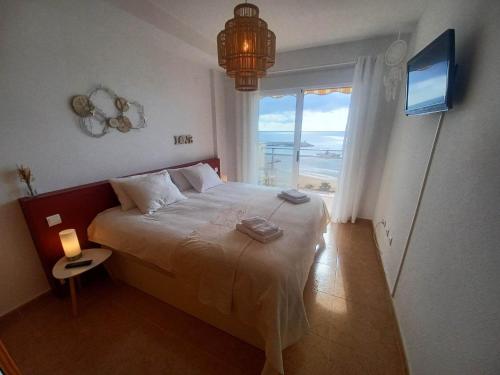 a bedroom with a bed with a view of the ocean at Seaview in Villajoyosa