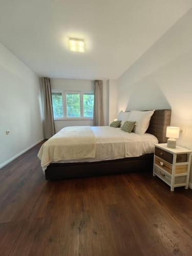 a bedroom with a large bed and a wooden floor at New 1 bedroom near Center and beach in Split
