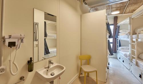 a bathroom with a sink and a mirror at Hostelfly in Madrid