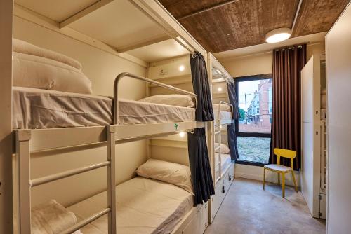 a room with bunk beds and a window at Hostelfly in Madrid