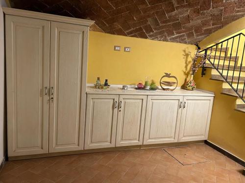 a bathroom with a sink and a yellow wall at A Casa di Marzia in Rapolano Terme