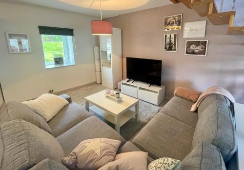 a living room with a couch and a table at An der Aubach in Haiger