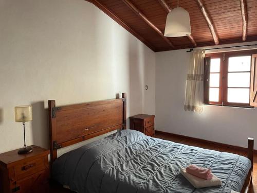 a bedroom with a bed and a window at Casa da Portela in Penacova