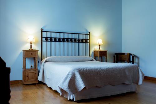 a bedroom with a bed and two night stands at El Molino de Bonaco in San Vicente de la Barquera