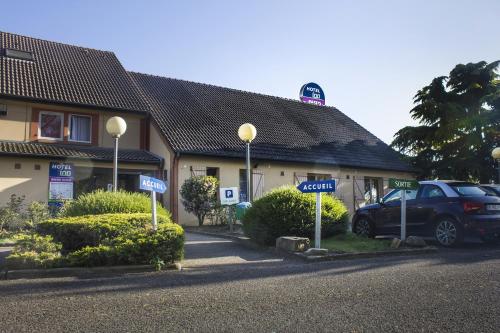 a car parked in front of a building at Hôtel Inn Design Resto Novo Bourges in Bourges